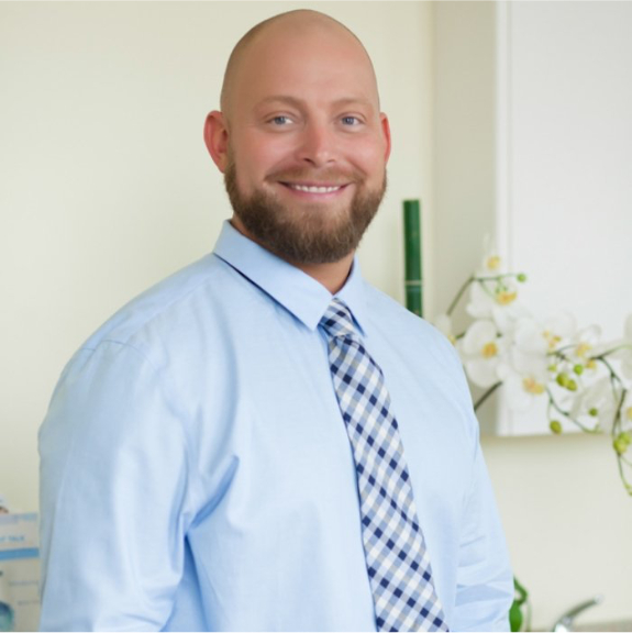 Dr. Ryan Johnson smiling with his family