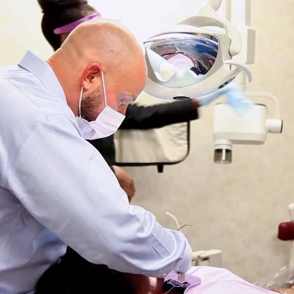 Dr. Ryan Johnson working on patient